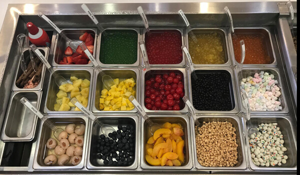 An overhead shot of fruit and candy toppings
